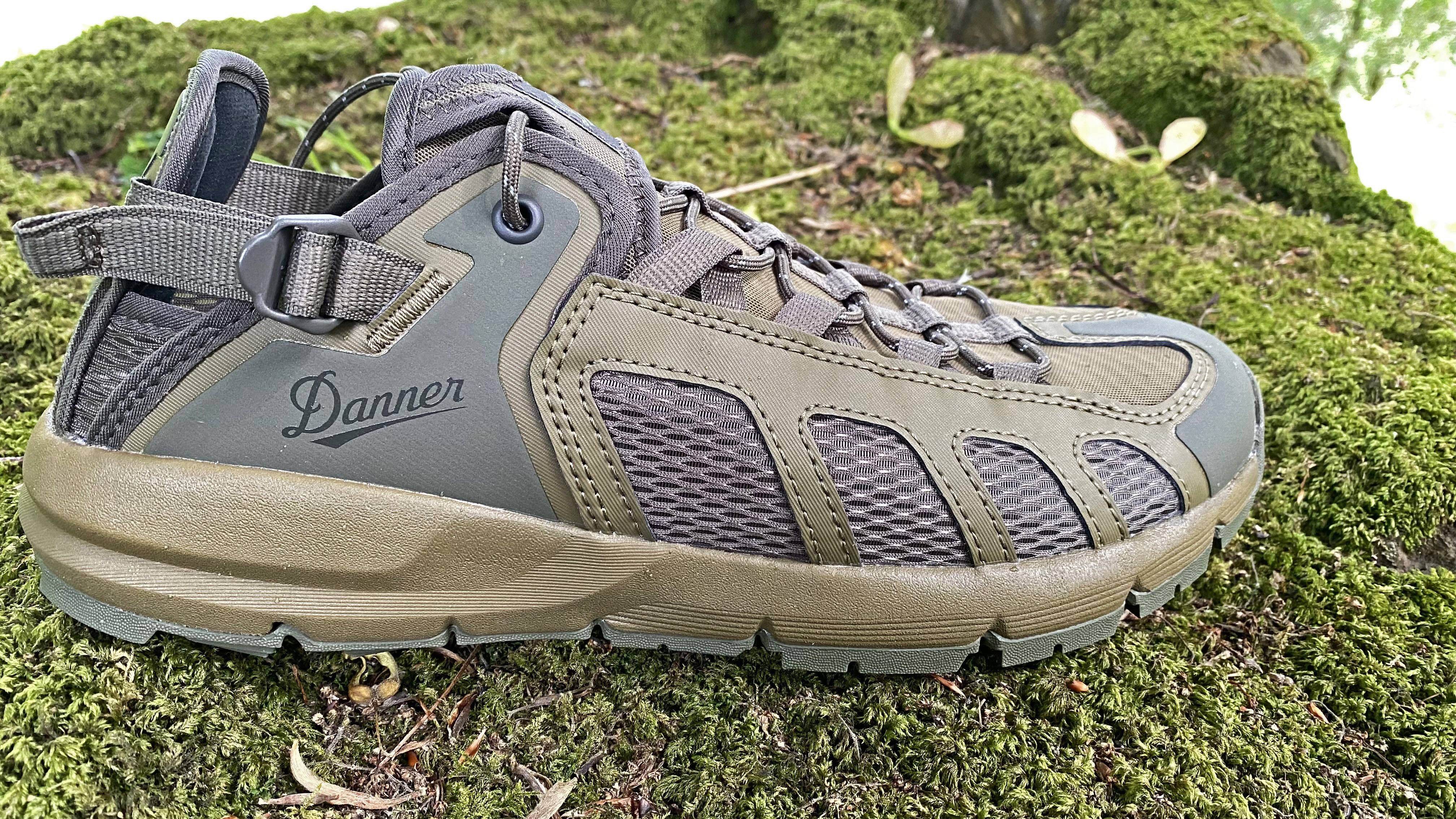 The Danner Fullbore Sandals in side profile on a moss-covered rock