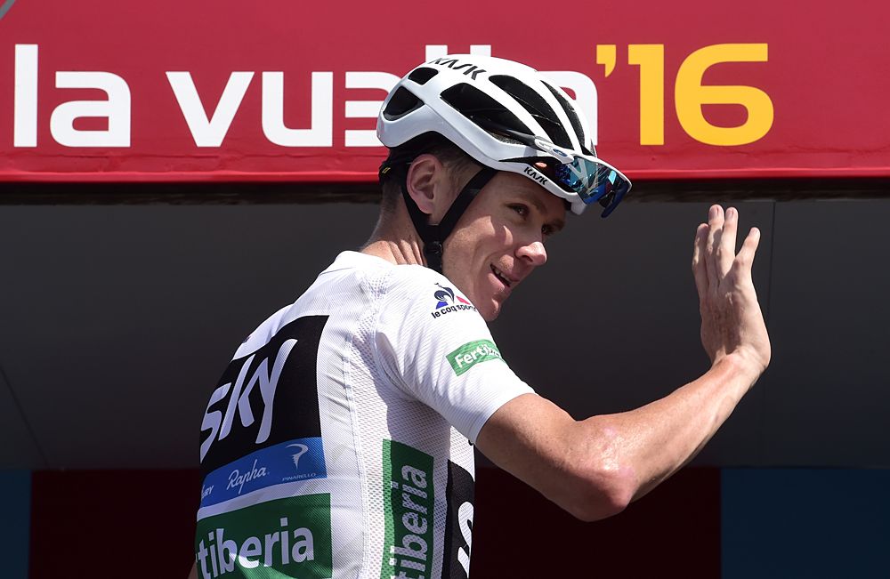 Chris Froome waves to fans from the stage 17 sign-on stage