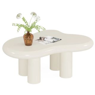 wavy, white coffee table with vase on it