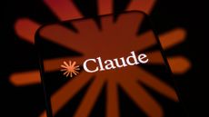 Logo and branding of Anthropic's Claude AI tool pictured on a smartphone screen, with branding blending into background.