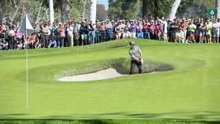 Rory McIlroy takes a shot from the bunker of the sixth green at Riviera Country Club