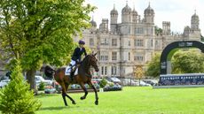 2025 Burghley Young Event Horse five-year-old winner Quantum Leap, with Piggy March, canter in front of Burghley House.