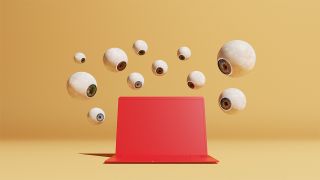 Floating eyeballs watching a red laptop