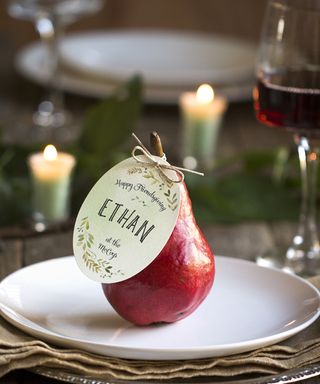 Thanksgiving place settings made with seasonal fruit and craft paper name tags