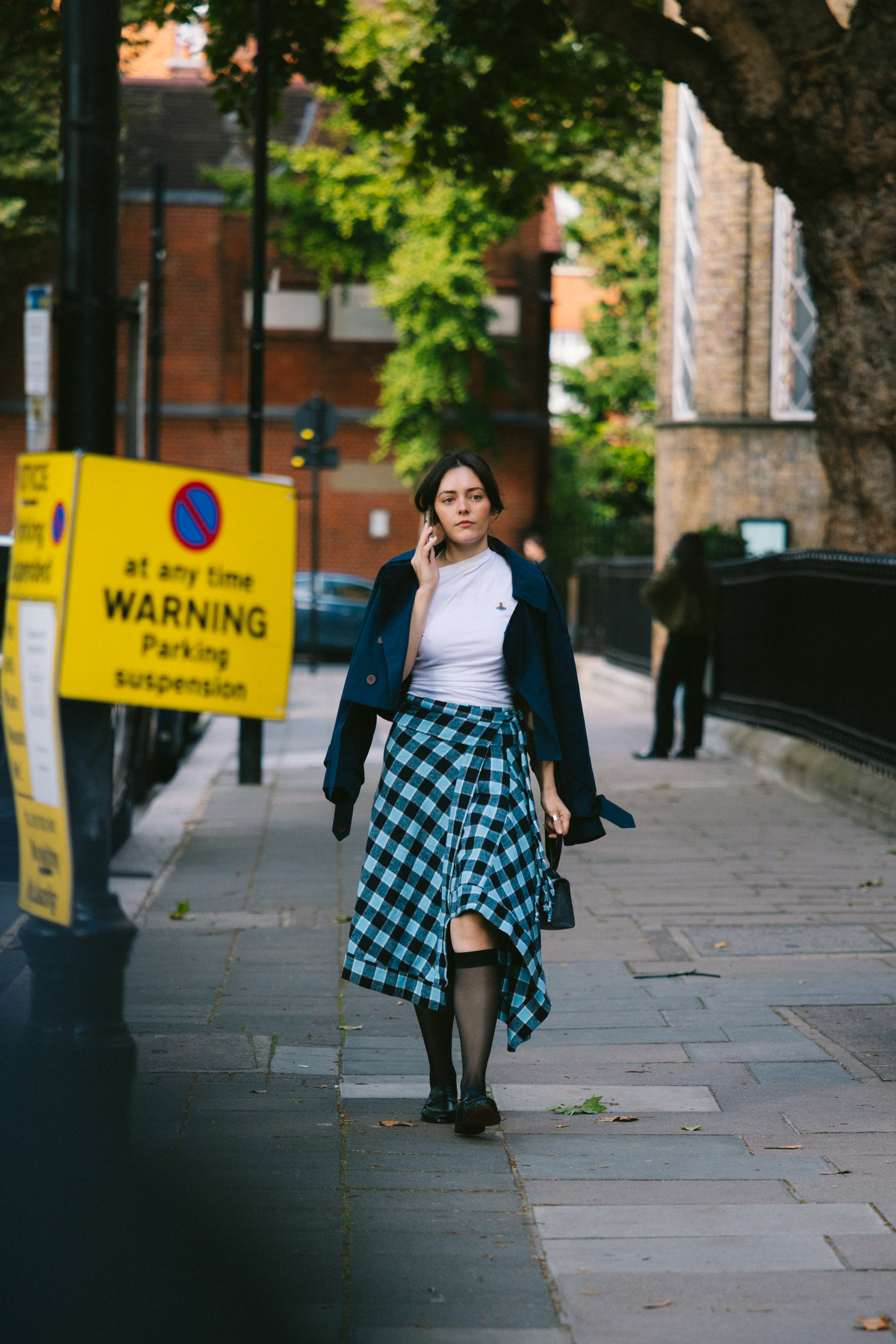 London Fashion Week attendees wears midi skirts with socks and loafers.