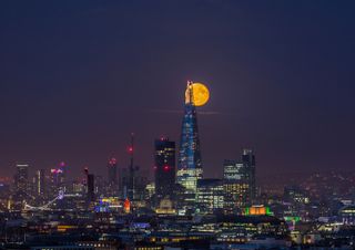 A burnt-orange moon hangs over London. Although scientists have unraveled many of the moon's mysteries in the 50 years since Apollo 11, mankind's enchantment with our nearest neighbor has never dimmed.