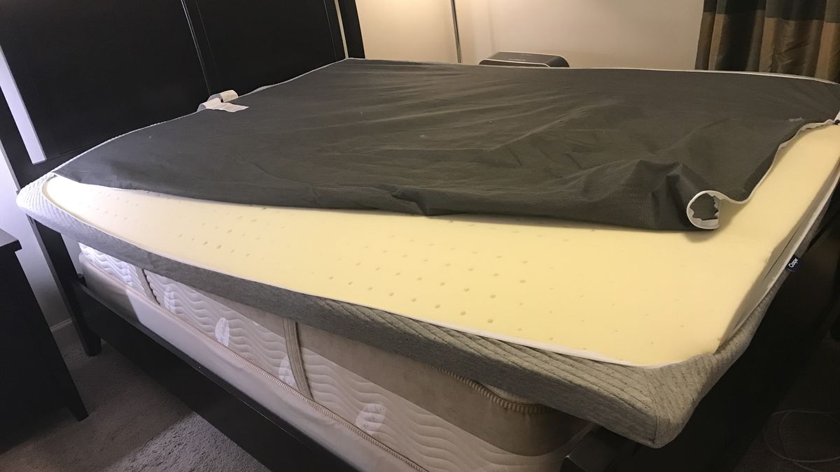 The Casper Comfy Mattress Topper cover being prepared to encase the foam topper.