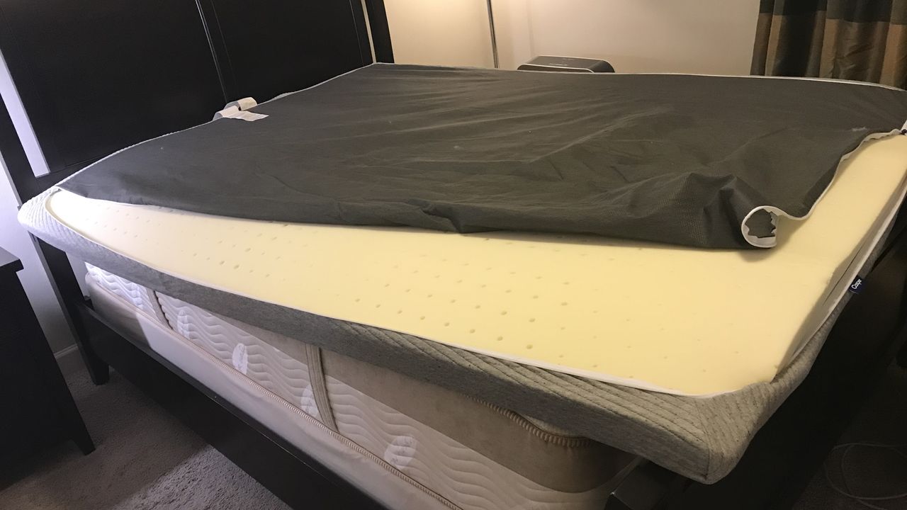 The Casper Comfy Mattress Topper cover being prepared to encase the foam topper.