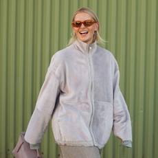 COPENHAGEN, DENMARK - AUGUST 06: Hollie Mercedes Peters wears grey zipper fleece jacket, long silver skirt, and dusty pink bag outside the Remain show during day two of the Copenhagen Fashion Week (CPHFW) SS25 on August 06, 2024 in Copenhagen, Denmark. (Photo by Raimonda Kulikauskiene/Getty Images)