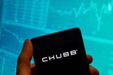 Chubb insurance company logo on smartphone with stock chart in the background