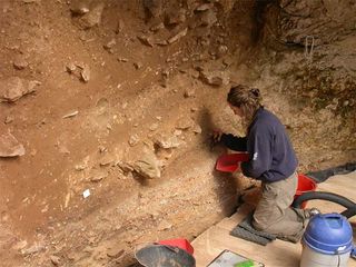 A scientist working at the Grotta di Fumane — "the Grotto of Smoke" — in northern Italy, a site loaded with Neanderthal bones.