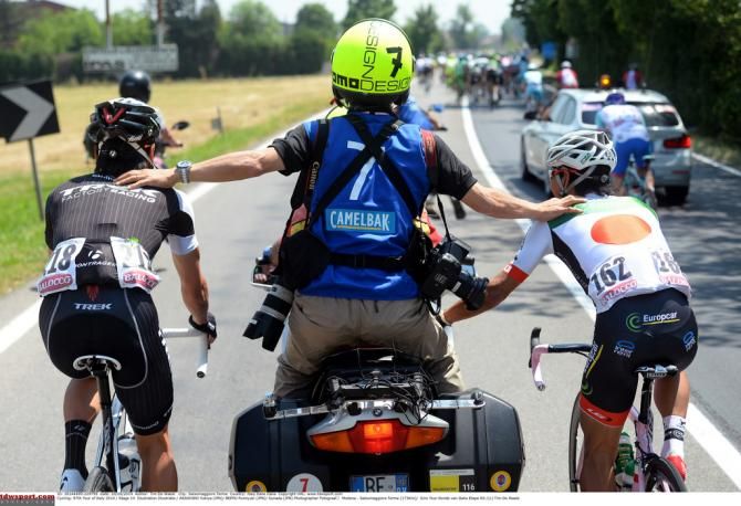 The two Japanese riders at the Giro being kept apart by a photographers moto