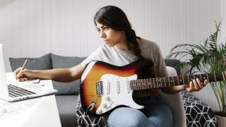 Best online guitar lessons 2021: Lady playing guitar at laptop