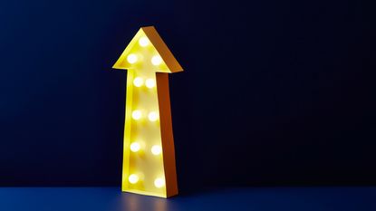 A light-up yellow arrow points up