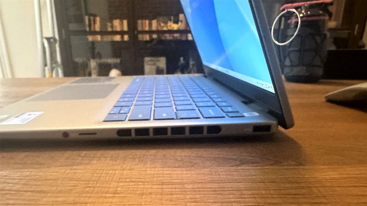 Side view of Dell Inspiron 14 Plus (7440) open on a wooden table