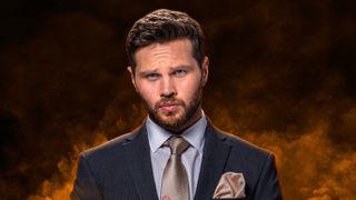 Keanu Taylor wearing a suit surrounded by yellow smoke in EastEnders promo shot