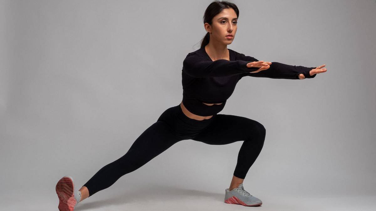 Woman performs cossack squat