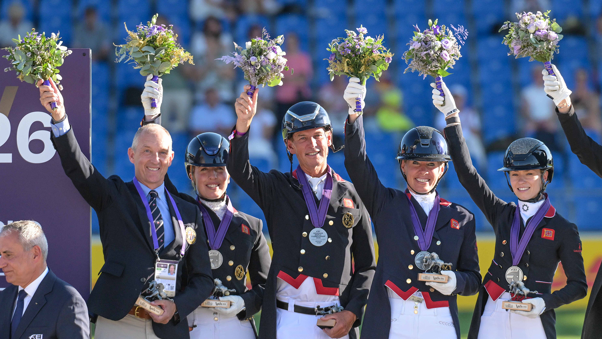 The British team of Fiona Bigwood, Becky Moody, Carl Hester and Lottie Fry stand on the podium with their silver medals at the 2026 FEI Dressage World Championship at Aachen