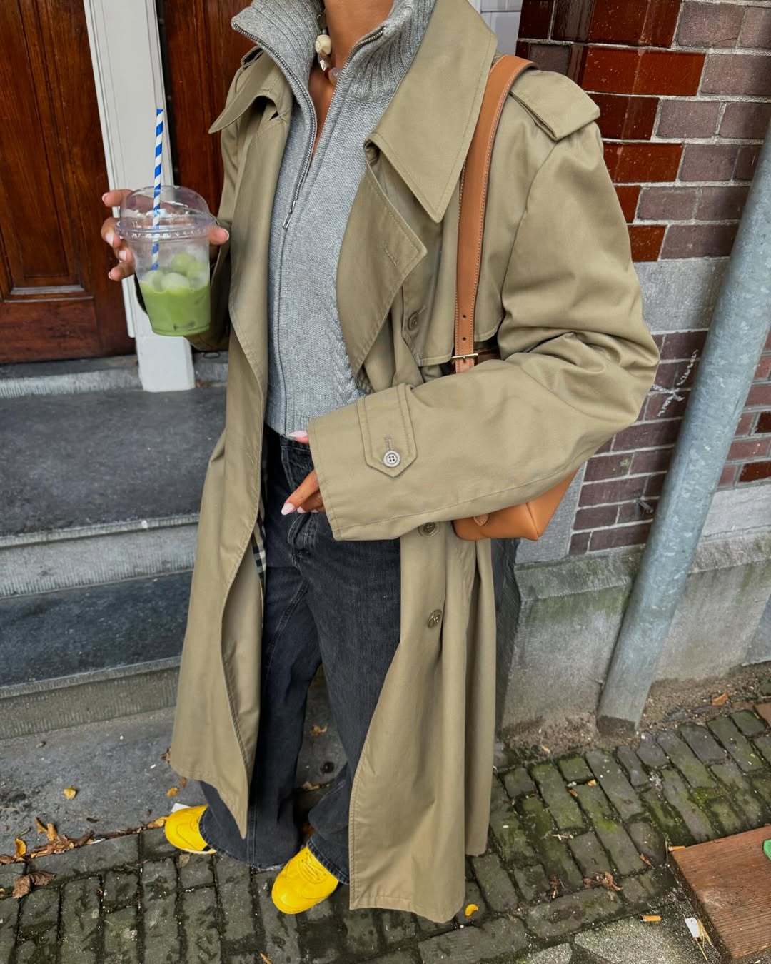 @amaka.hamelijnck wearing jumper, trench and jeans