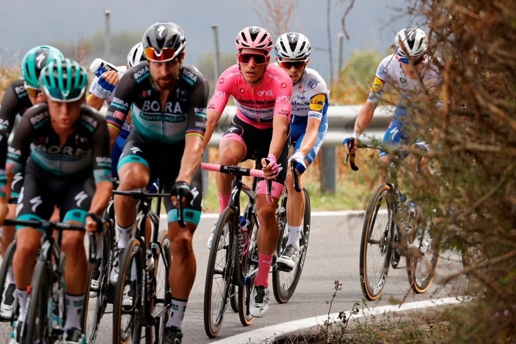 Team Deceuninck rider Portugals Joao Almeida C wearing the overall leaders pink jersey rides during the 4th stage of the Giro dItalia 2020 cycling race a 140kilometer route between Catania and Villafranca Tirrena Sicily on October 6 2020 Photo by Luca Bettini AFP Photo by LUCA BETTINIAFP via Getty Images