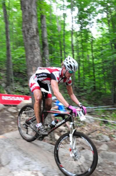 Mical Dyck (Trek Toronto) descending over some rocks.