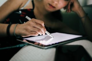 How to protect your eyes as a digital artist; a woman works on a tablet