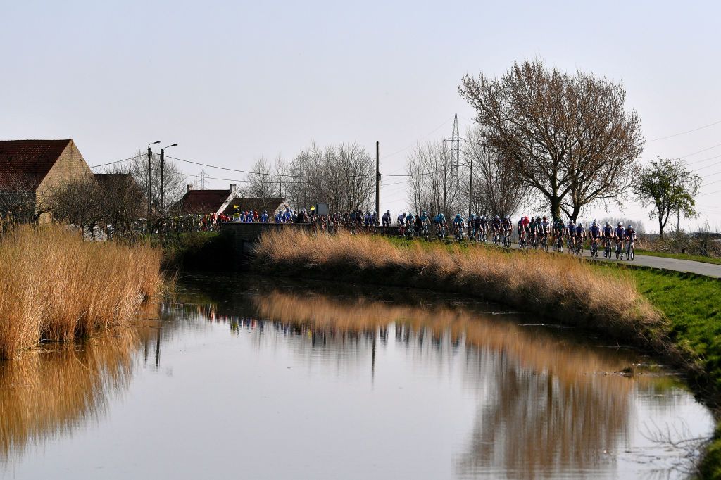 DE PANNE BELGIUM MARCH 23 A general view of the peloton passing through a landscape during the 46th Minerva Classic Brugge De Panne 2022 a 2079km stage from Brugge to De Panne MinervaClassic on March 23 2022 in De Panne Belgium Photo by Luc ClaessenGetty Images