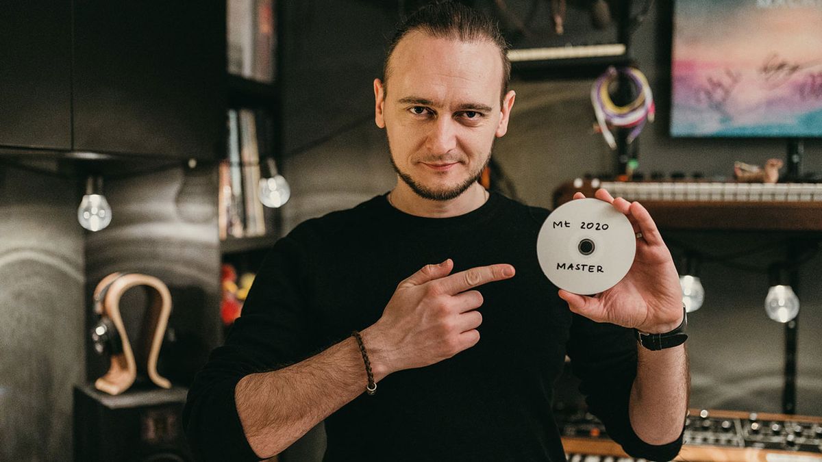 Michal Lapaj in the studio holding a CD master