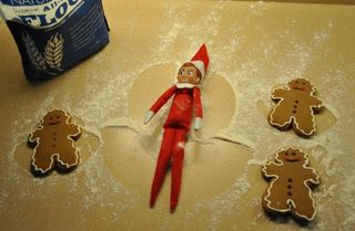 an elf on the shelf making a sugar angel