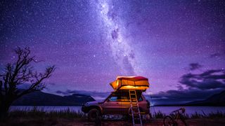 Starry night with backdrop of southern alps of New Zealand and beautiful Lake Ohau in South Island, New Zealand.