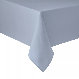 A light blue tablecloth at the corner of a table