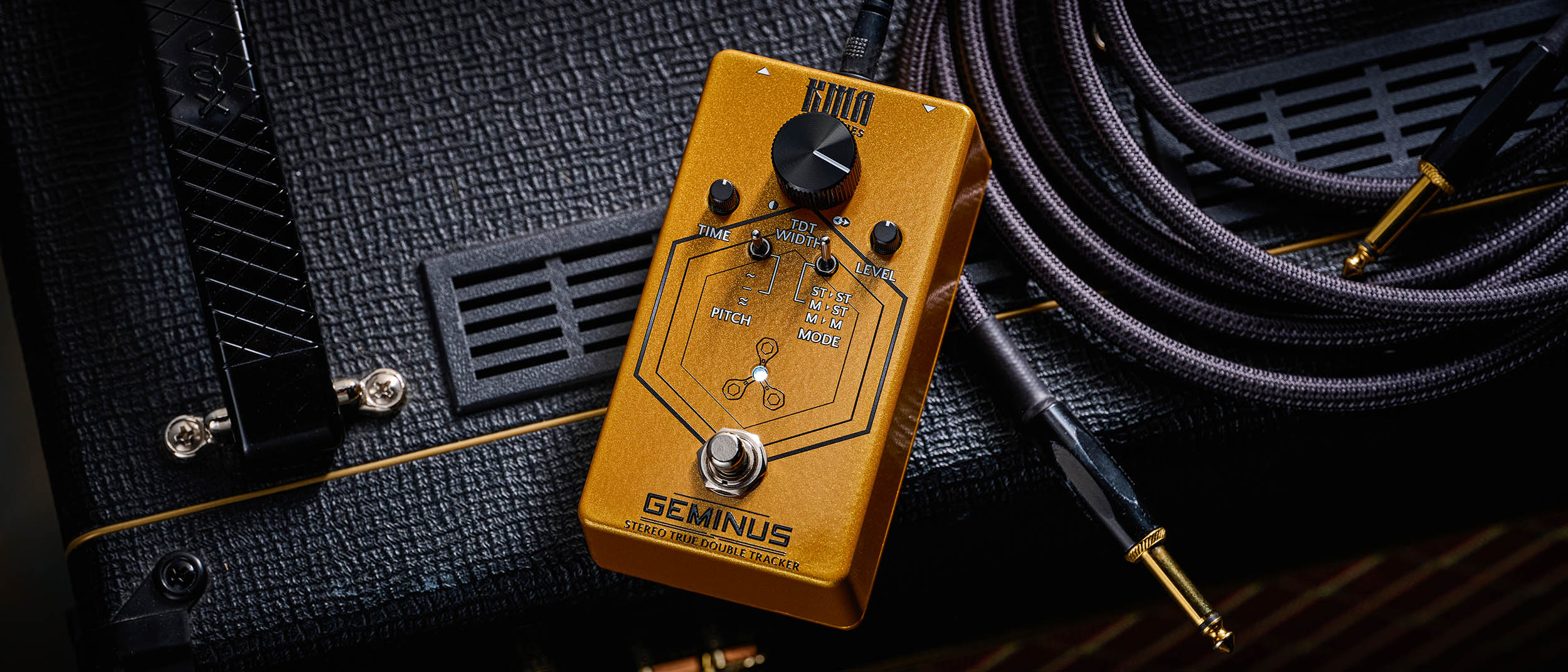 KMA Geminus Stereo True Double Tracker: the gold stompbox&#039;s fascia is dominated by one large black dial and is photographed here in close-up.