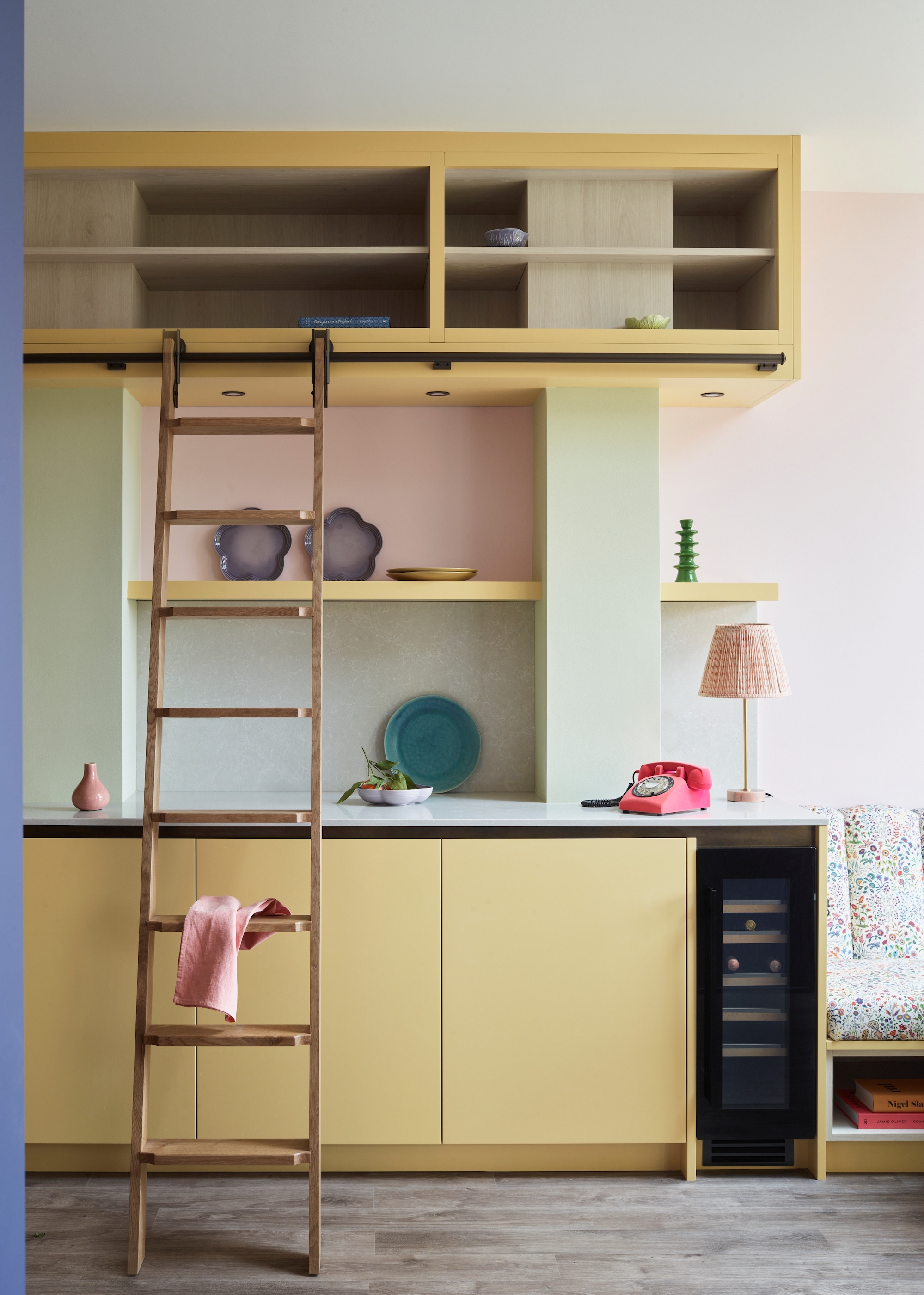 kitchen in pastel tones with a ladder on a rail