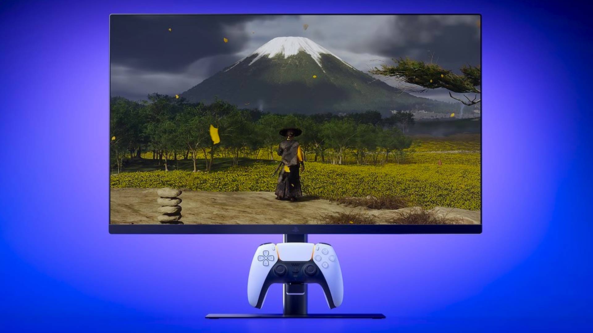 PlayStation Monitor with DualSense on charging hook and Ghost of Yotei gameplay on screen.