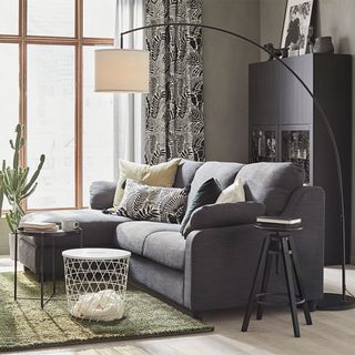Grey living room with sofa and arc floor lamp
