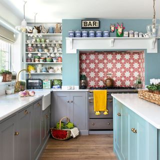 kitchen with marble worktop and grey cabinets with basket