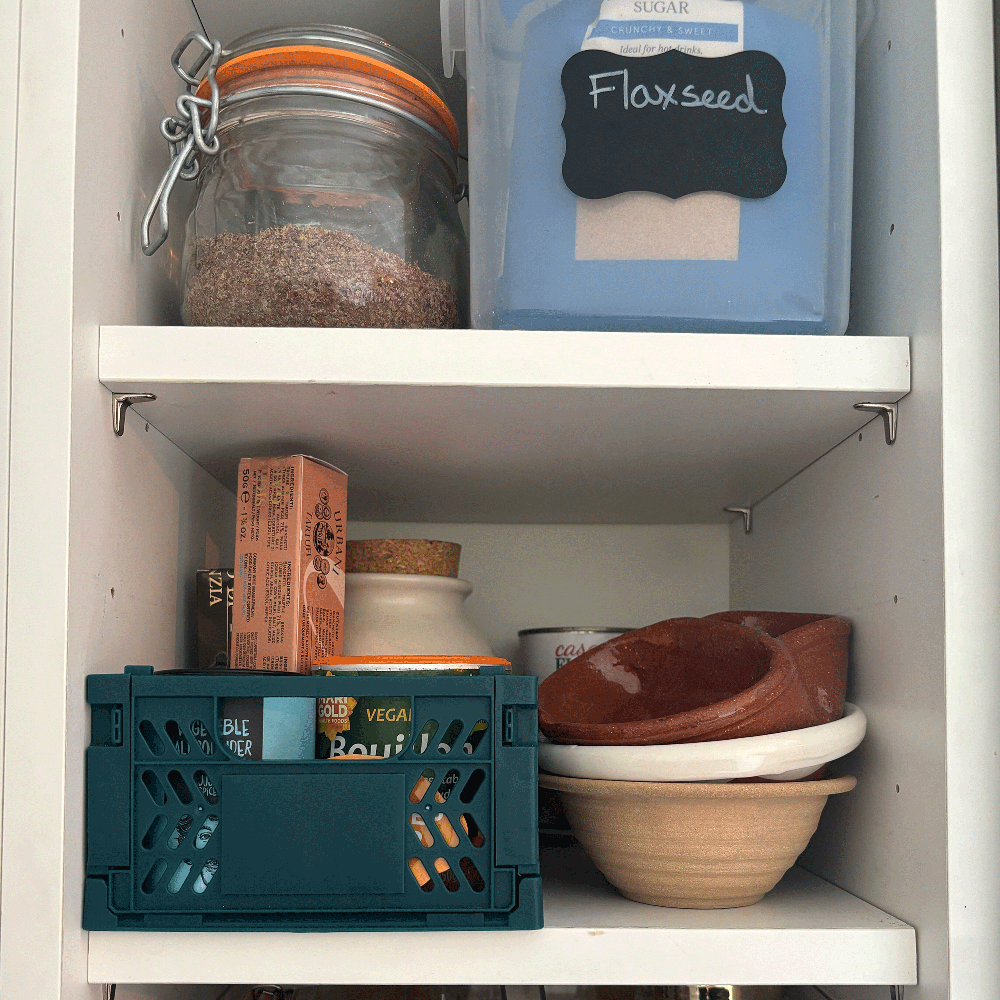 Primark storage crates in a white kitchen cabinet