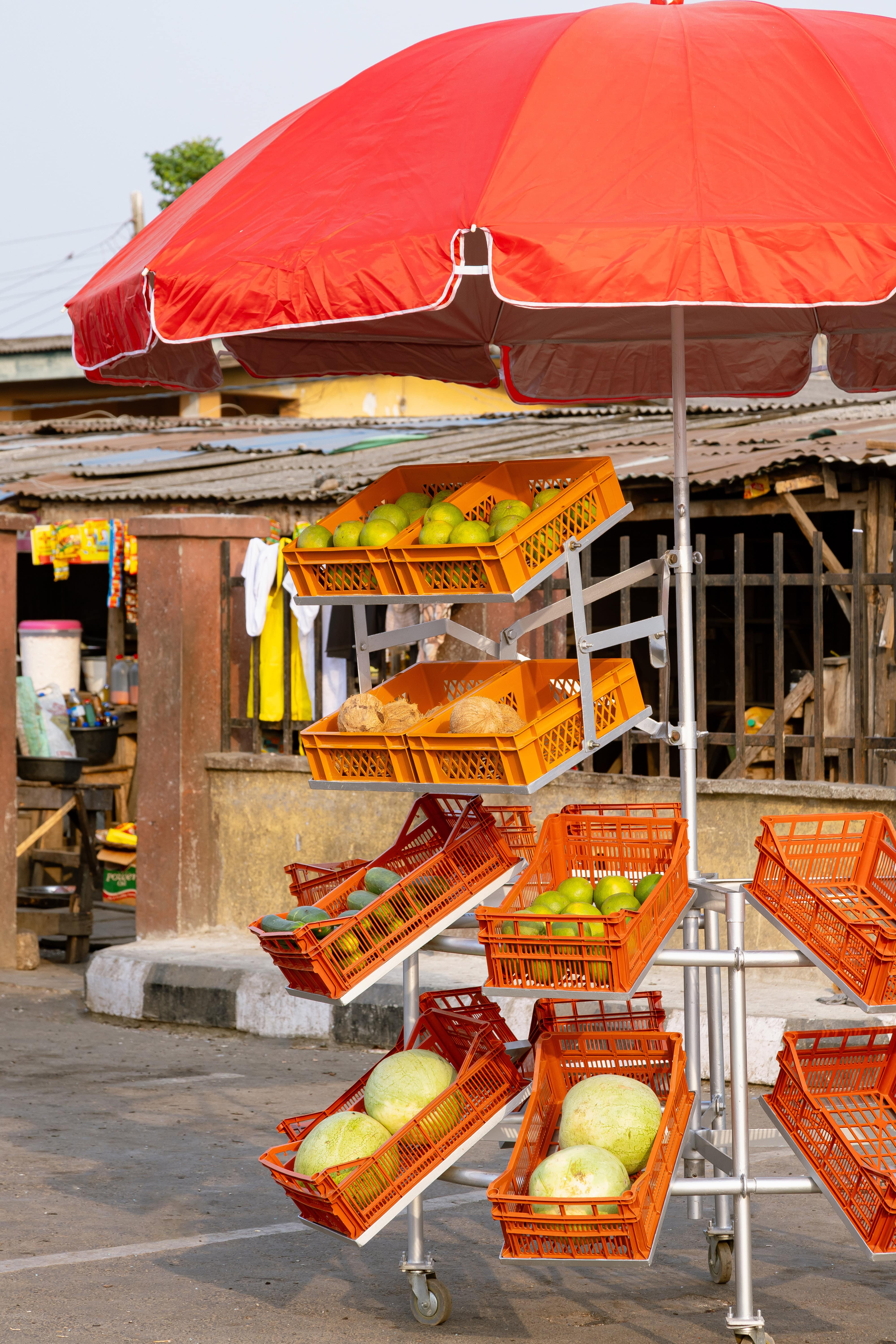 Metal street market stall with red umbrella
