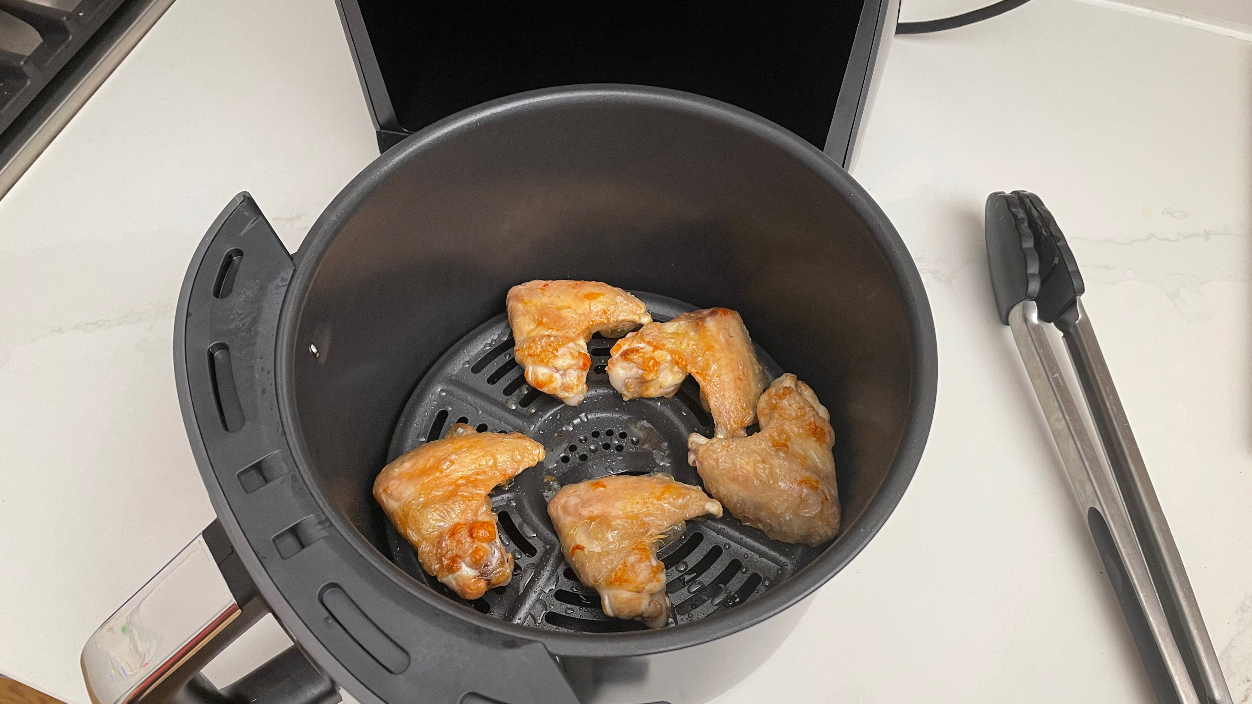 The Ninja Air Fryer Max AF160 with chicken wings that have just been cooked in it