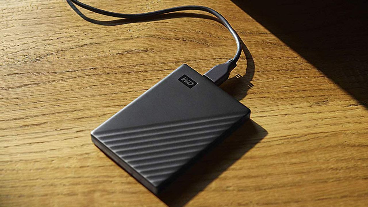 Official image of the WD 4TB My Passport Portable drive, sitting on a wooden table.