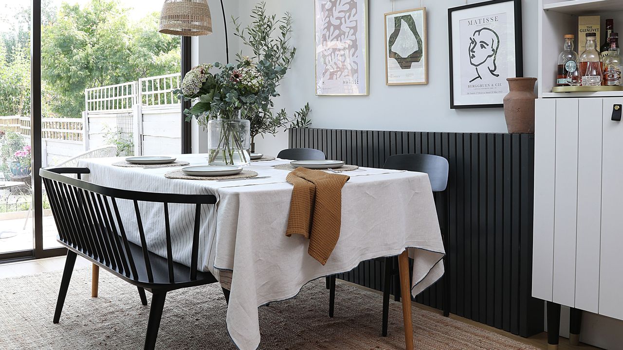 Dining area with table, bench seating and gallery wall