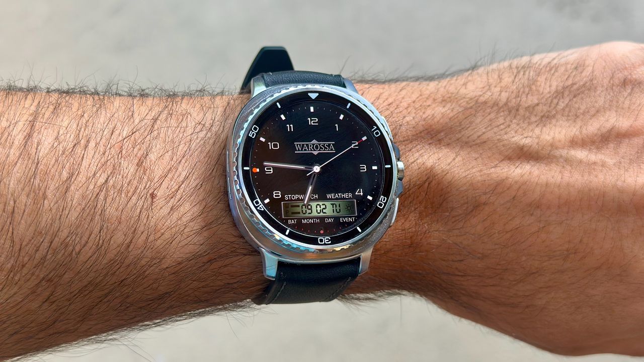 The Samsung Galaxy Watch 8 Classic on a person's wrist, showing a custom watch face from the WatchMaker app imitating a Warossa watch.