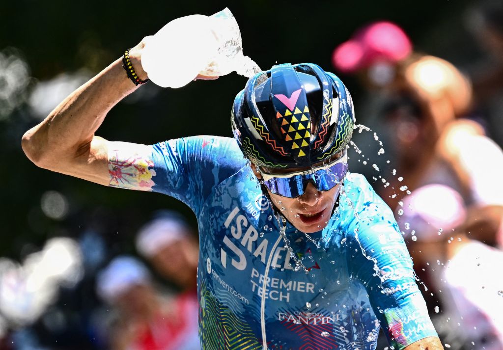 IsraelPremier Tech teams British rider Chris Froome cools down with water as he cycles the ascent of the Col de la Croix de Fer during the 12th stage of the 109th edition of the Tour de France cycling race 1651 km between Briancon and LAlpedHuez in the French Alps on July 14 2022 Photo by Marco BERTORELLO AFP Photo by MARCO BERTORELLOAFP via Getty Images