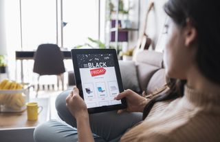 Shopping online Black Friday sales using a tablet at home