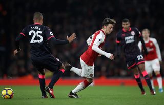 Mesut Ozil of Arsenal turns Mathias Jorgensen of Huddersfield Town during the Premier League match between Arsenal and Huddersfield Town at Emirates Stadium on November 29, 2017 in London, England. (Photo by Julian Finney/Getty Images)