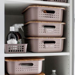 Labelled baskets in linen cupboard