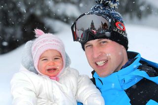 Prince William, Duke of Cambridge (R) poses with his daughter Princess Charlotte (L) during a private break skiing at an undisclosed location in the French Alps on March 3, 2016. / AFP / POOL