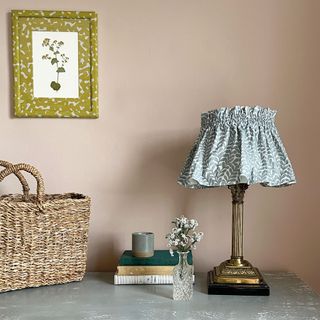 Pink wall with frilly blue lamp