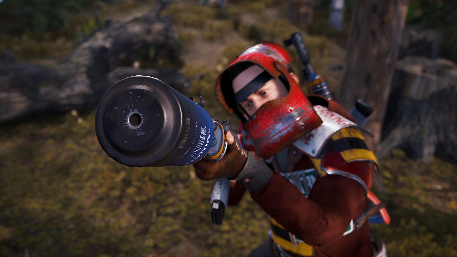 A Rust survivor clad in makeshift armour holding a gun with a homemade silencer toward the camera.