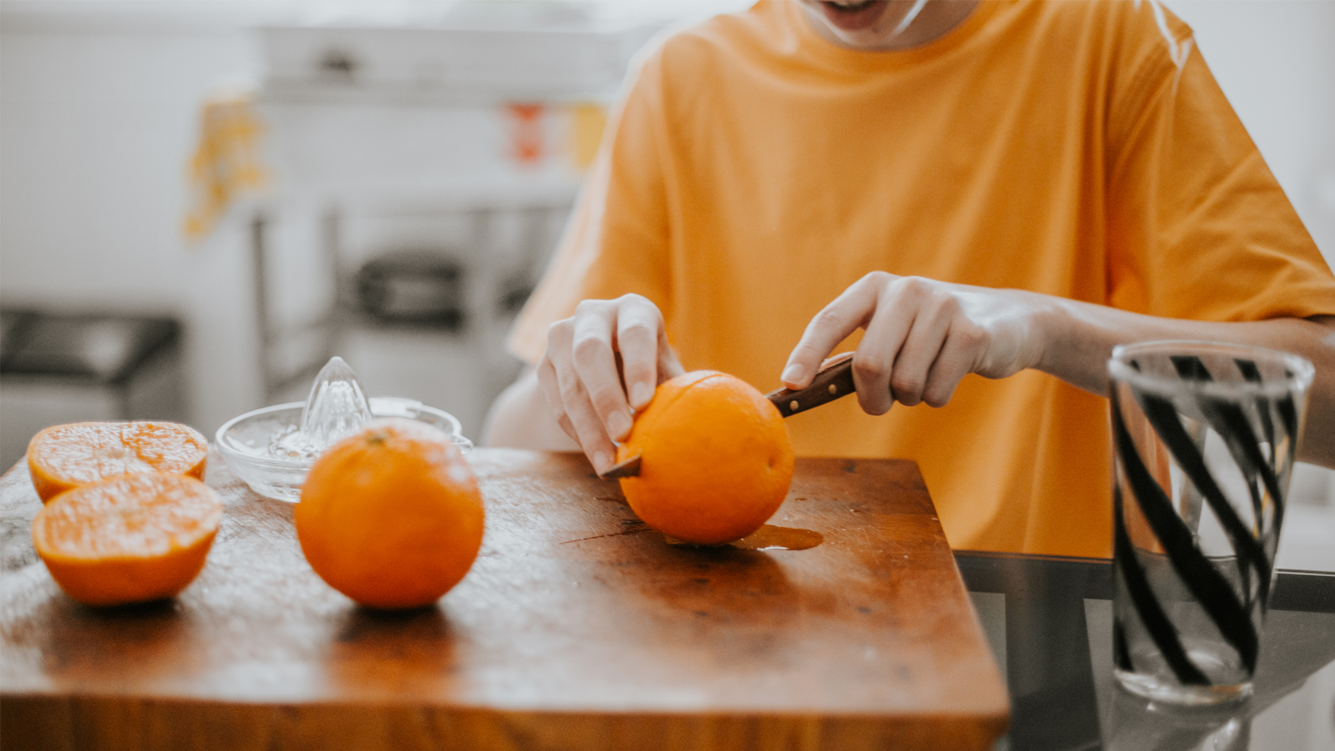 Image of a woman slicing oranges